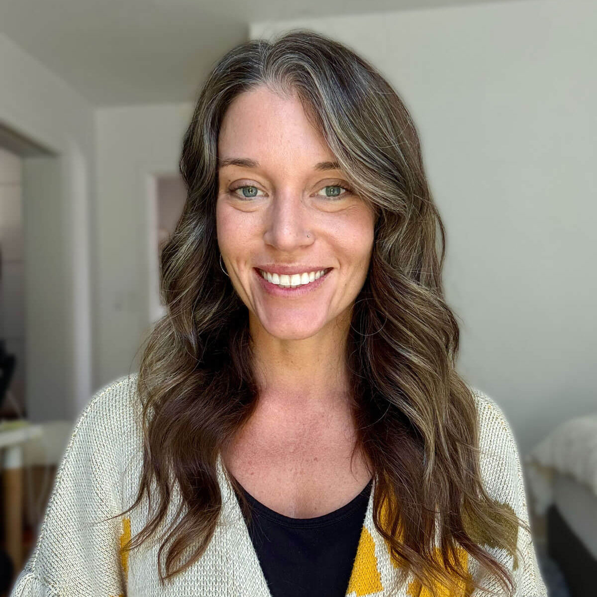 Woman wearing a patterned cardigan in an indoor setting